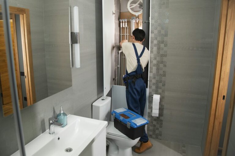 Plumber repairing bathroom plumbing
